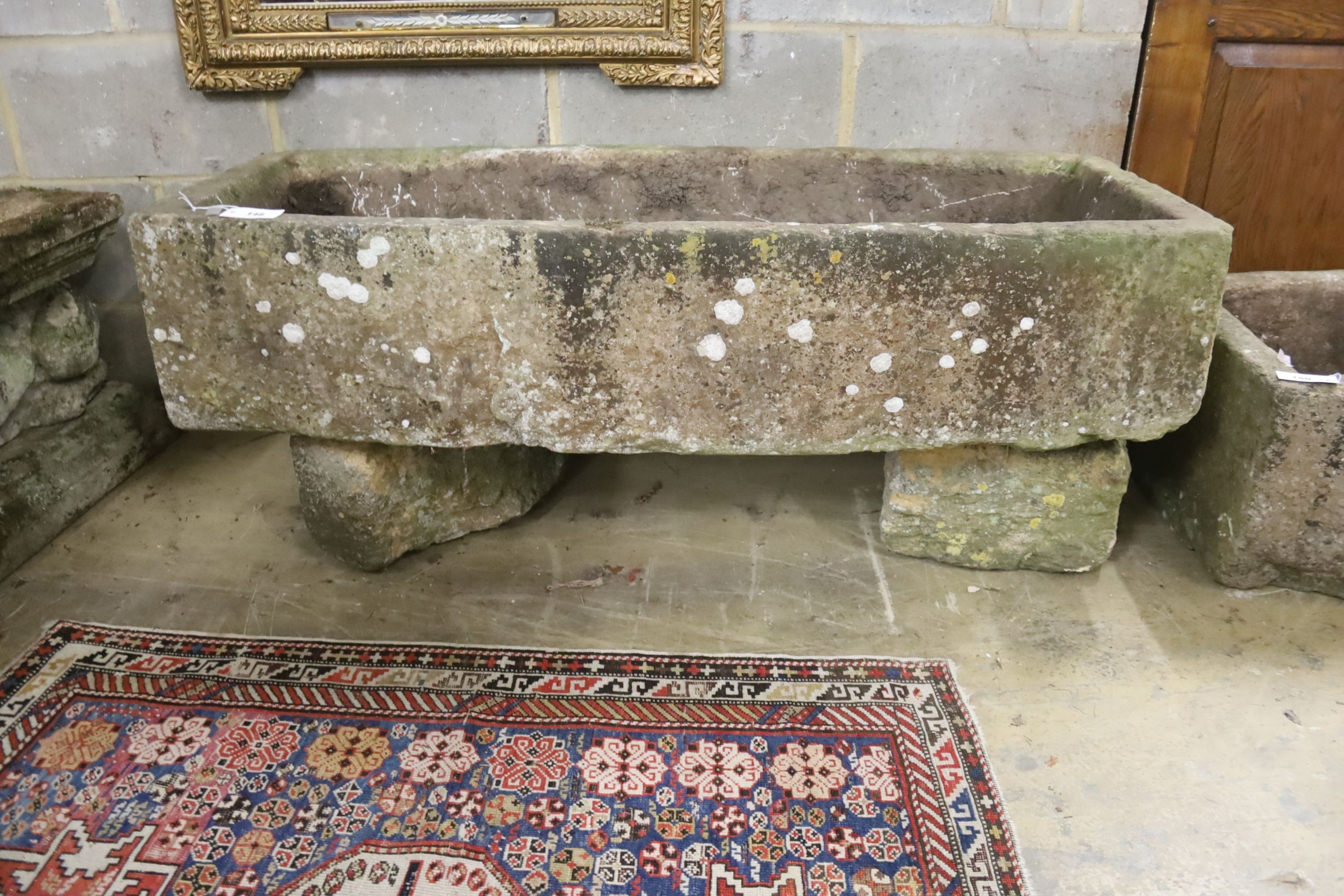 A 19th century carved stone bow fronted trough, length 133cm, depth 57cm, height 54cm